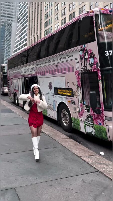 Roopsi Bansal enjoying afternoon tea aboard a Tea Around Town NYC sightseeing bus tour in Midtown Manhattan