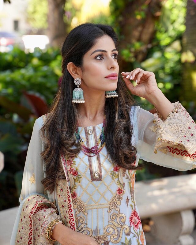 Close-up of Roopsi Bansal wearing mint green jhumka earrings from Jaipur Rose and an embroidered pale blue Khas kurta with a floral-embroidered dupatta