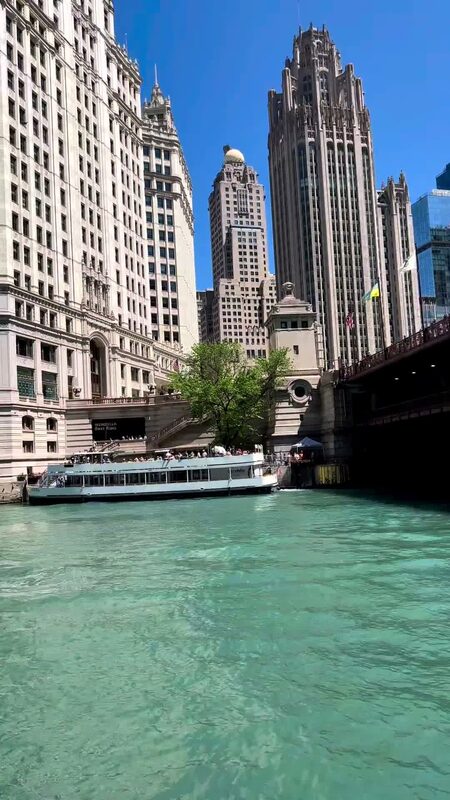 A sightseeing boat on the Chicago River in front of the Wrigley Building and Tribune Tower