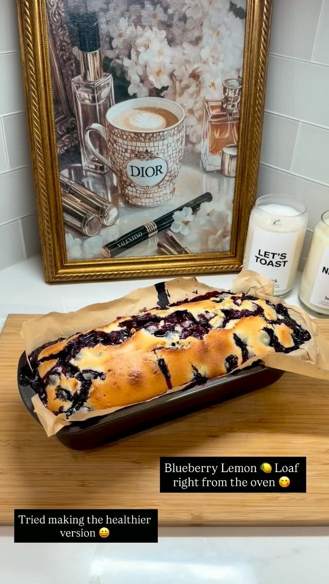 A blueberry lemon loaf fresh out of the oven on a wooden board