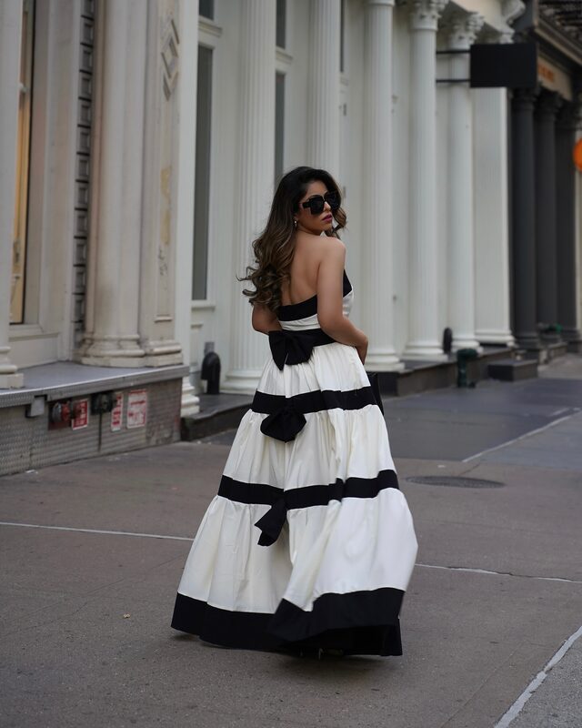 Roopsi Bansal in a white striped bowknot maxi dress on a New York City street