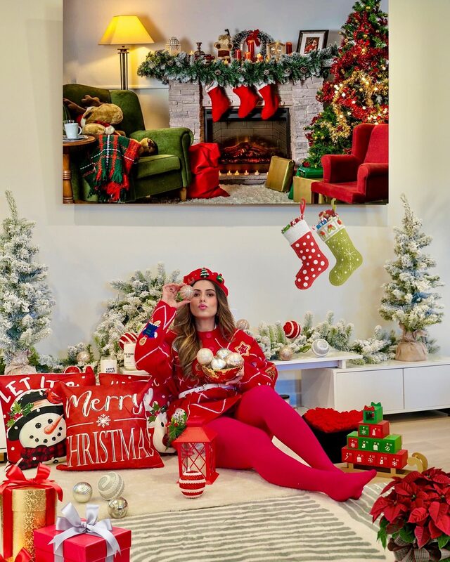 Roopsi Bansal in red tights beside a Christmas tree from King of Christmas