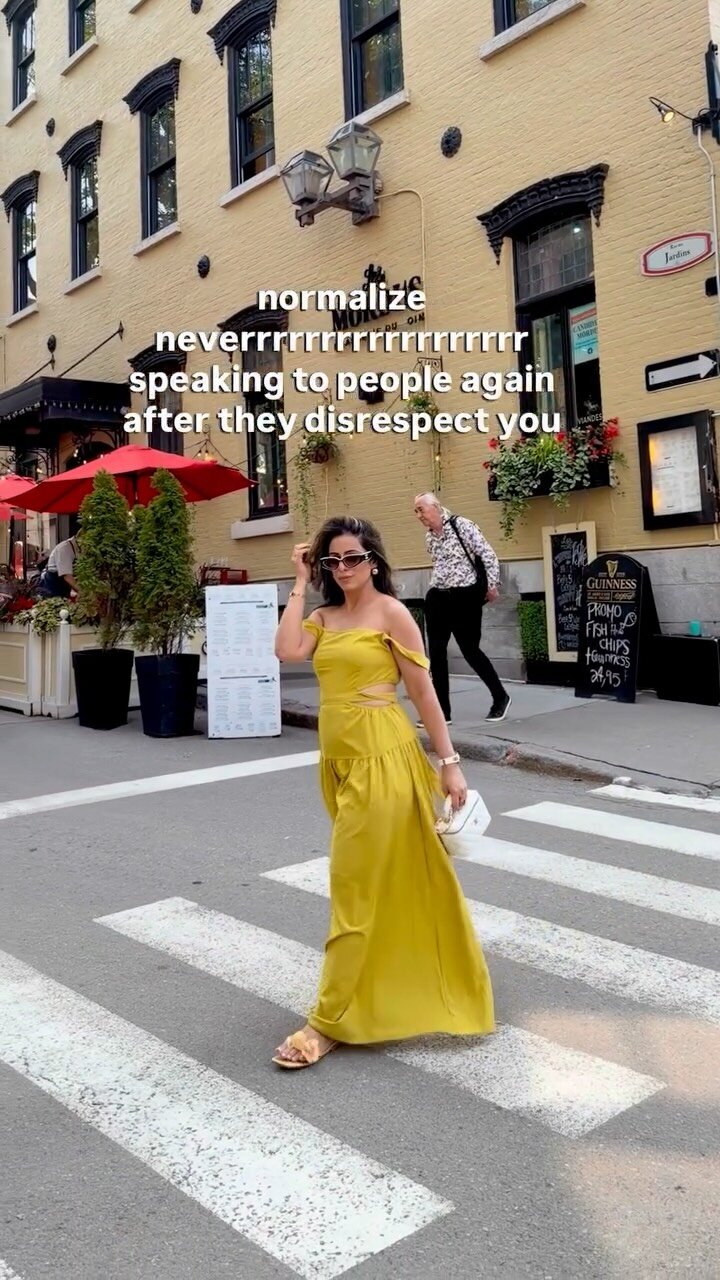 Roopsi Bansal in a mustard off-shoulder cutout maxi dress and sunglasses, crossing a crosswalk on a cafe-lined street, with on-screen text reading normalize never speaking to people again after they disrespect you
