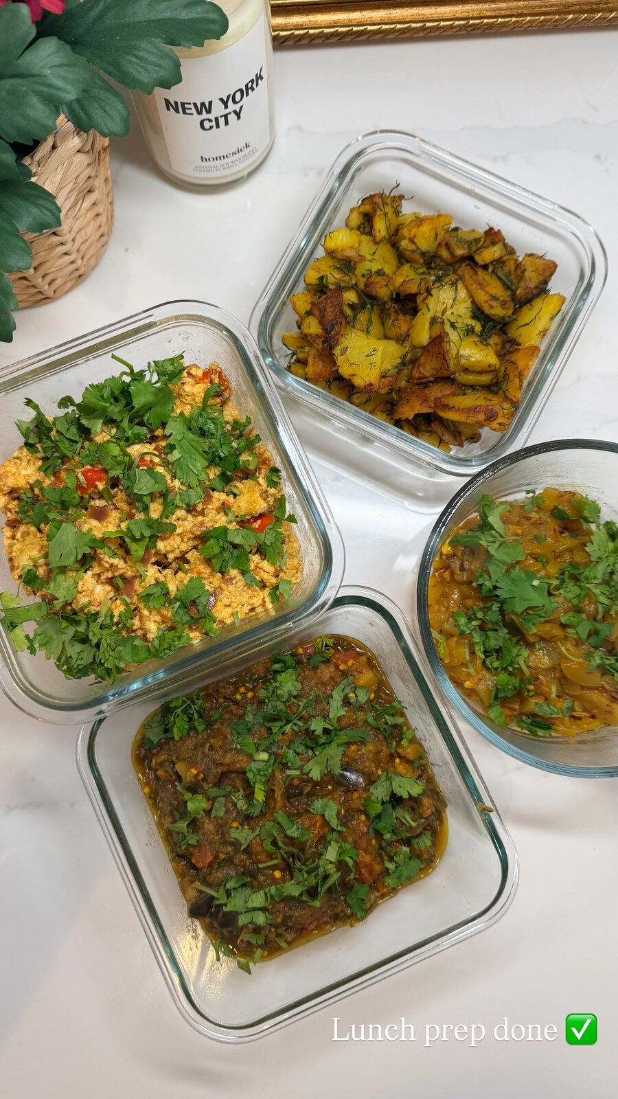 Meal-prepped lunches in glass containers, including baingan bharta, aloo, and egg bhurji