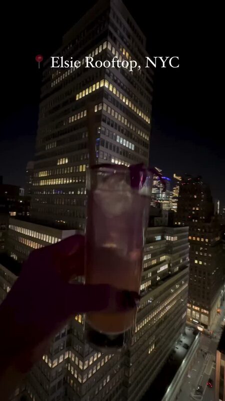 Roopsi Bansal at Elsie Rooftop in NYC with city views behind her, wearing Chicwish