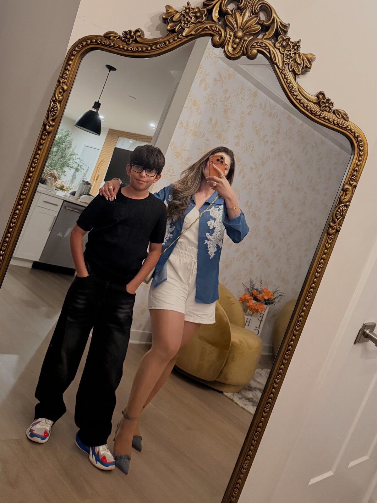 Mother and son mirror selfie in an ornate gold mirror