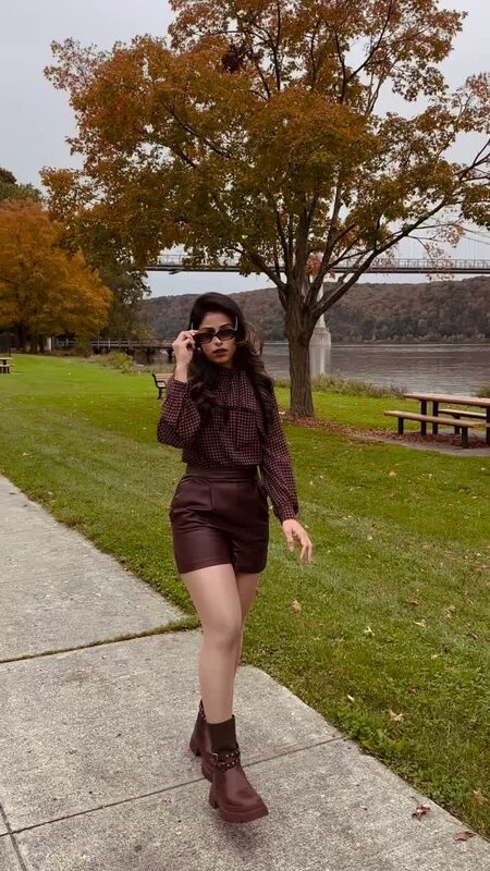 Express — The Express faux-leather romper, riverside with a bridge view.
