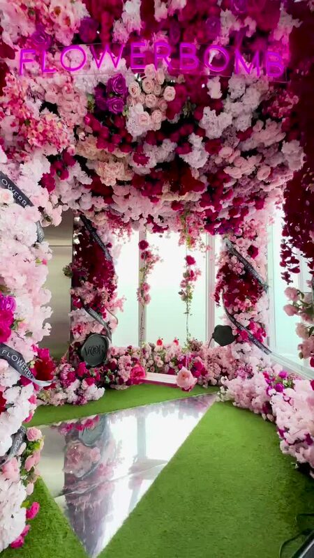 An immersive floral archway installation called Flowerbomb at Edge NYC