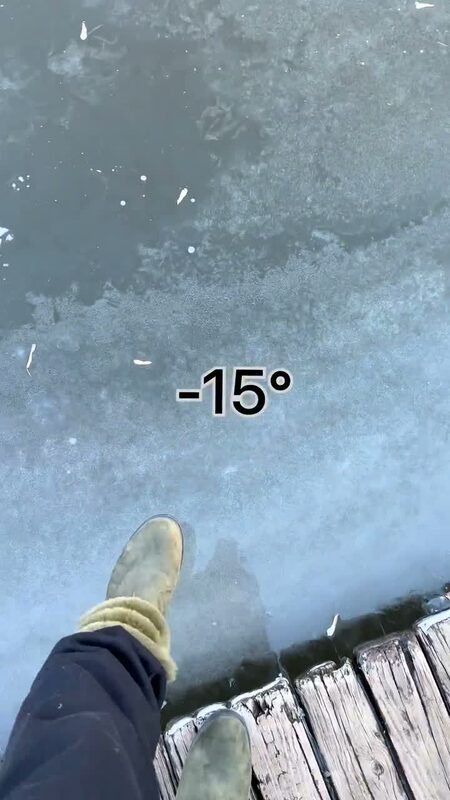 A boot stepping onto a fully frozen lake at Turning Basin Park with a -15 degree temperature overlay