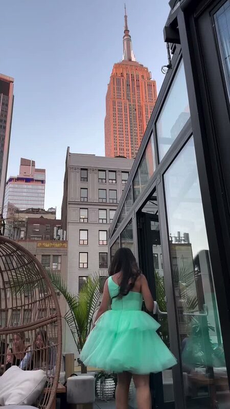 Roopsi Bansal in a mint green tulle dress on the rooftop of Glass Ceiling NoMad with the Empire State Building in view