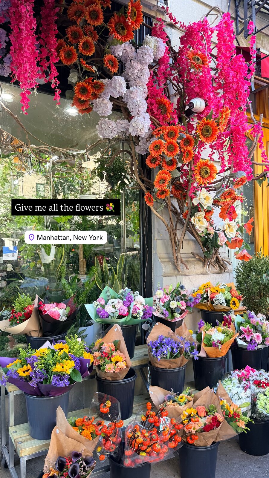 A Manhattan flower stand with buckets of colorful bouquets and hanging blooms