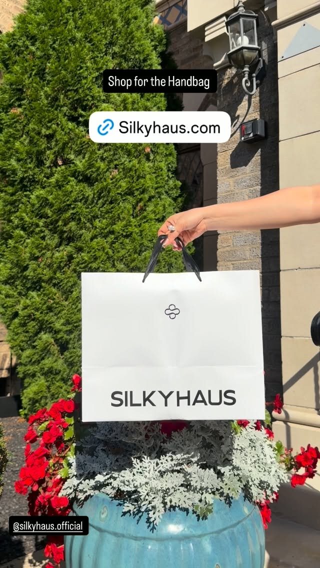 A Silkyhaus shopping bag held up outside, tagged @silkyhaus.official