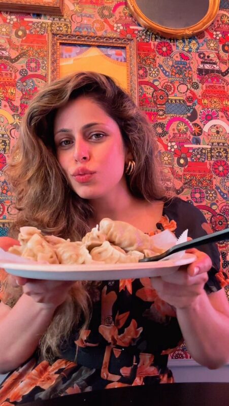 Roopsi Bansal trying momos at Fomomo in the East Village