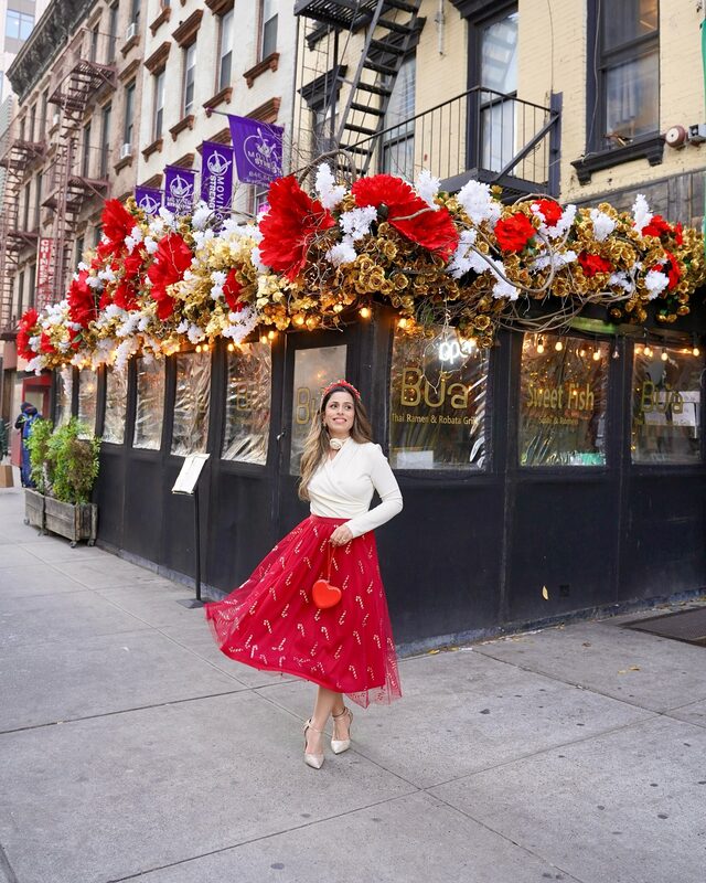 Roopsi Bansal in a red skirt from Chicwish at Buatha Ramen and Robata Grill