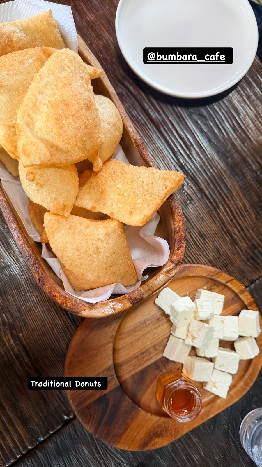 Traditional fried donuts served with cubed feta cheese and honey at Cafe Bubamara
