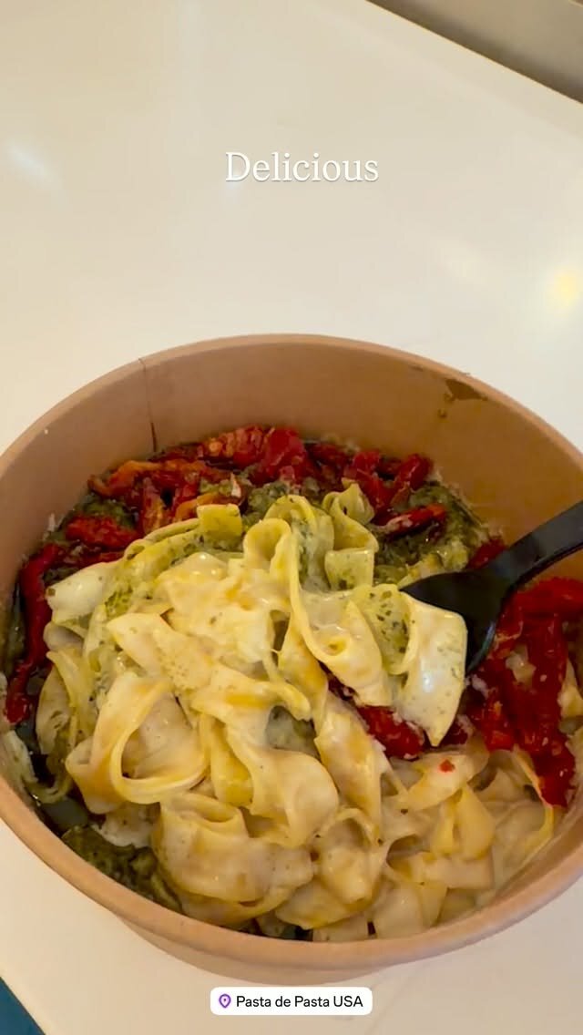A bowl of tagliatelle in pesto sauce topped with sun-dried tomatoes from Pasta de Pasta USA