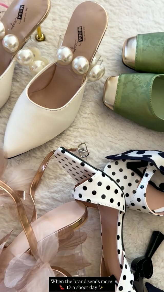 A flat lay of pearl-trimmed mules, sage green flats, and polka-dot heels laid out for a shoot
