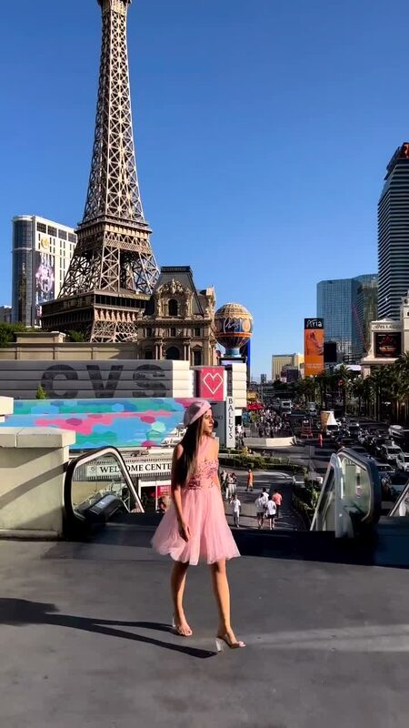 Roopsi Bansal in a pink tulle dress on the Las Vegas Strip with the Eiffel Tower replica in the background