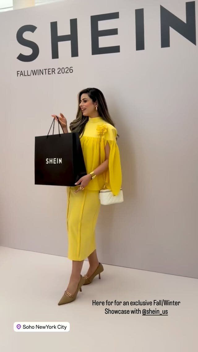 Roopsi Bansal in a yellow dress holding a black SHEIN shopping bag at the SHEIN Fall/Winter 2026 showcase in Soho, New York City