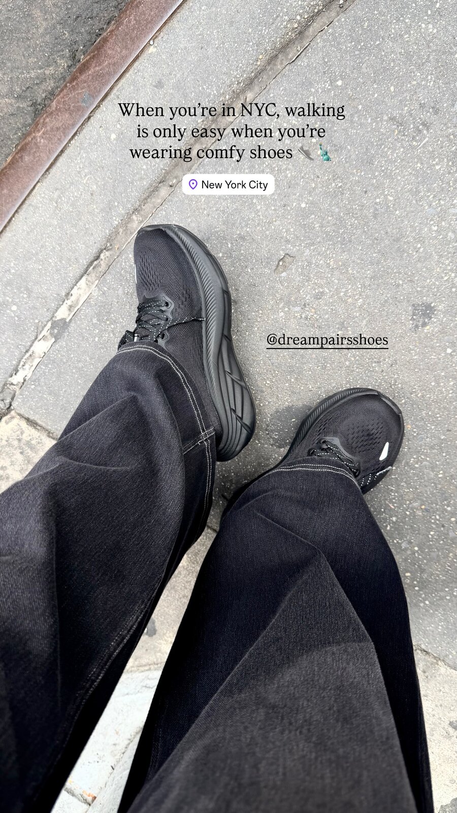 A pair of feet in black sneakers standing on a New York City sidewalk