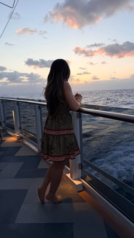 Roopsi Bansal watching a sunset on a cruise