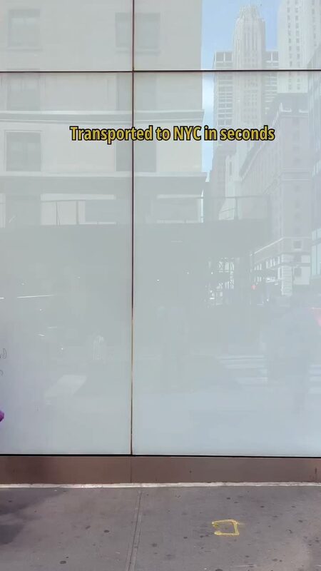 Roopsi Bansal in New York City with a rose pink AnyZip carry-on suitcase, wearing a Queen of Sparkles feather dress