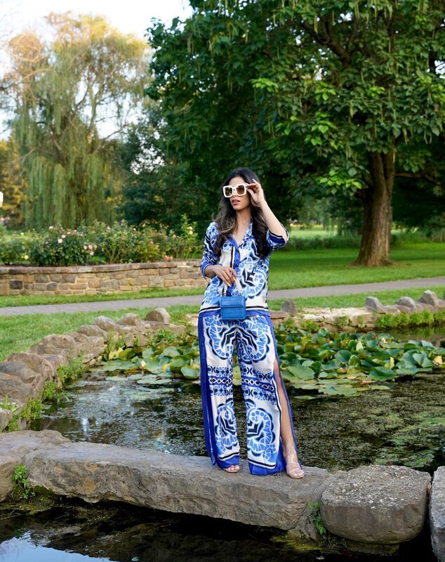 Roopsi Bansal in a printed long sleeve shirt and drawstring slit hem pants from MICAS, carrying a Tijn handbag