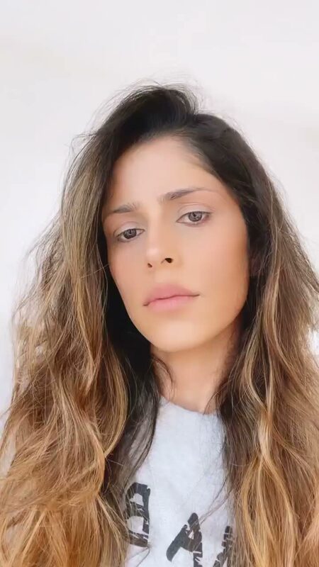 Close-up of Roopsi Bansal's bare, dewy skin before a makeup transition