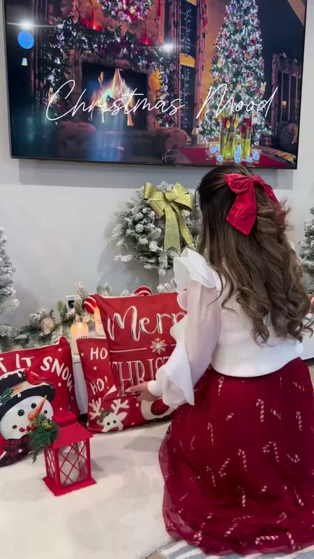 Roopsi Bansal decorating for the holidays with King of Christmas, wearing a Chicwish top and skirt