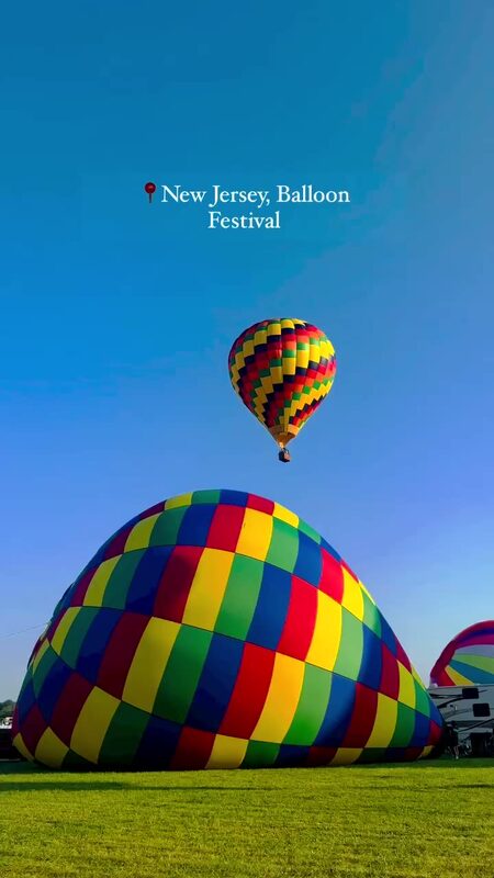Roopsi Bansal at the New Jersey Festival of Ballooning with hot air balloons filling the sky at Solberg Airport