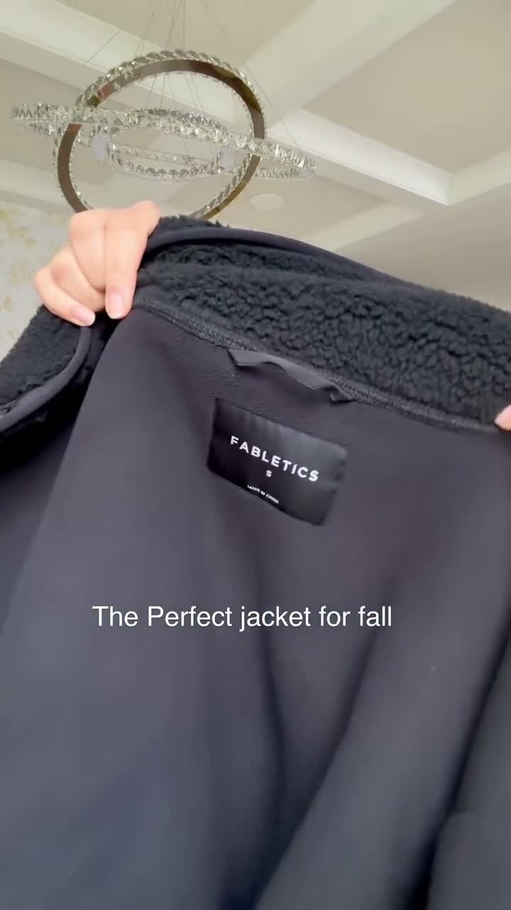 Close-up of a black sherpa jacket showing the Fabletics label