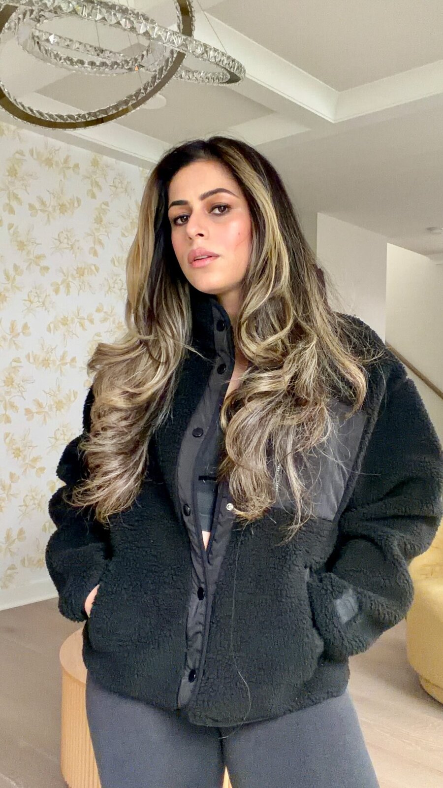 Roopsi Bansal in a black Fabletics sherpa jacket