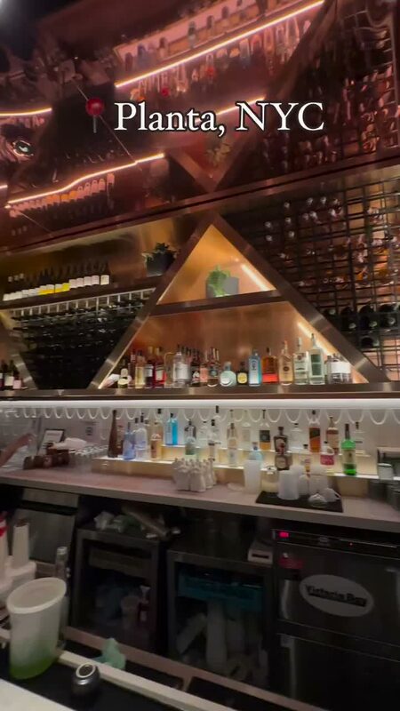The geometric, gold-lit bar at Planta, a plant-based restaurant in NYC
