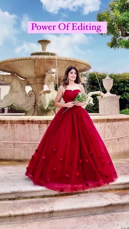 Roopsi Bansal in a red rose-petal ball gown in front of a horse-statue fountain, with 'Power Of Editing' text overlaid on the video