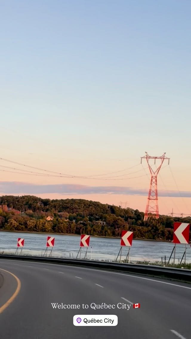 A highway curving along the St. Lawrence River at dusk with a transmission tower in the distance, captioned Welcome to Quebec City