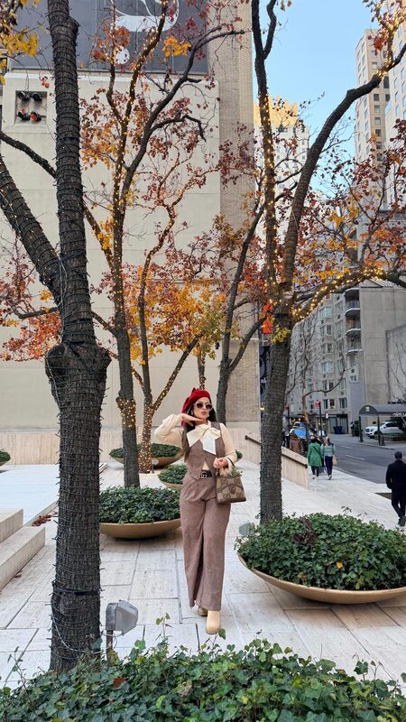 Roopsi Bansal enjoying retro NYC Christmas lights in Dream Pairs boots