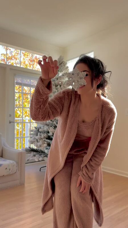 Roopsi Bansal in a cozy mauve sherpa set beside a flocked Christmas tree from King of Christmas at home