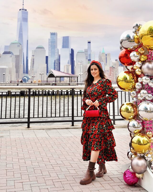 Roopsi Bansal in a ruffle dress from Chicwish with a city skyline view