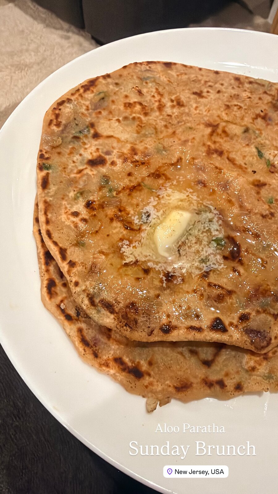 A plate of aloo paratha with melting butter, labeled Sunday Brunch