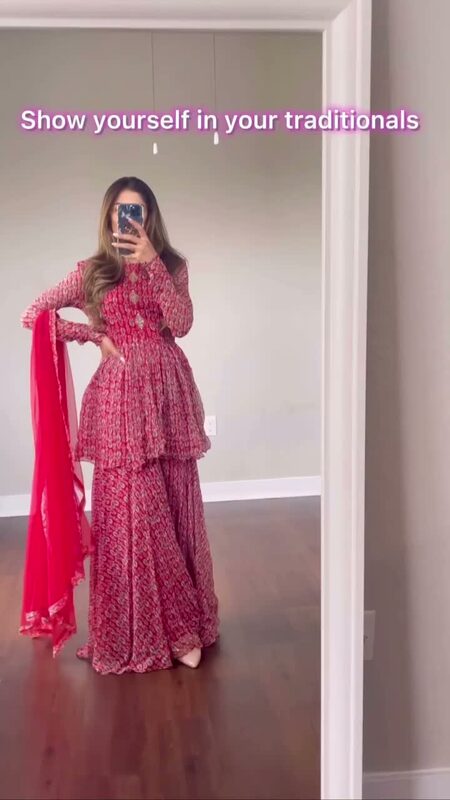 Roopsi Bansal in a red printed peplum-top and sharara set with a matching red dupatta, posing in a mirror at home