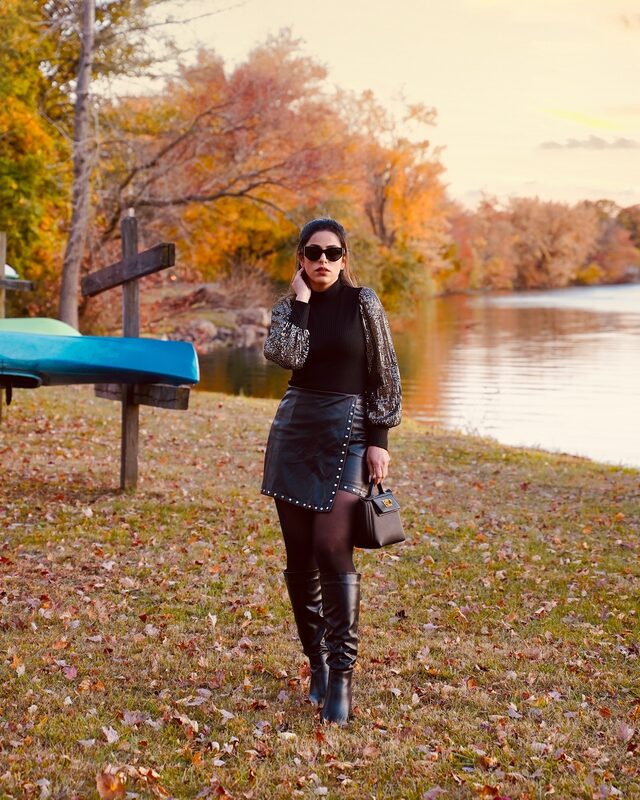 Roopsi Bansal in a black sequin mesh knit top from Chicwish