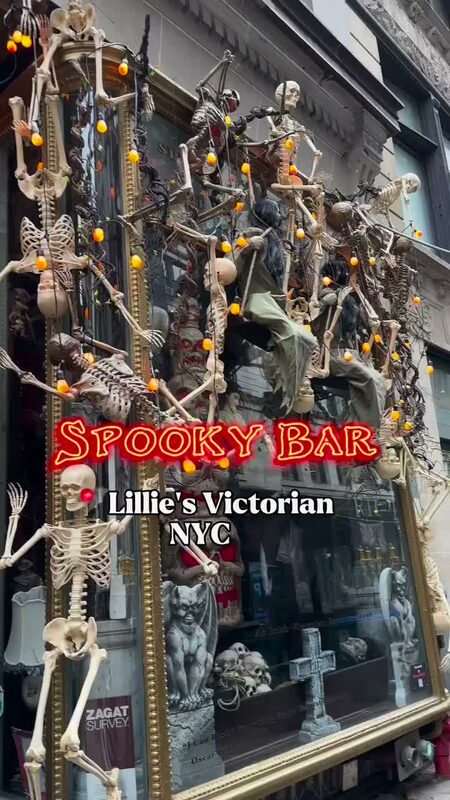 A skeleton-covered Halloween window display outside Lillie's Victorian restaurant in NYC