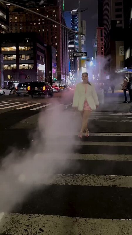 Roopsi Bansal in a coat and heels walking through New York City