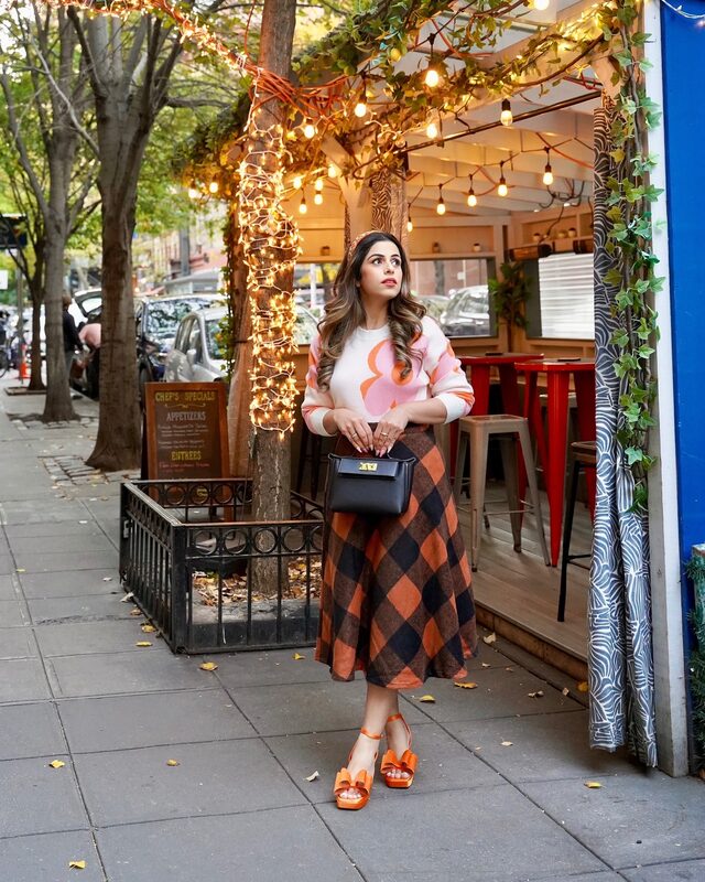 Roopsi Bansal in a Chicwish sweater and skirt with Dream Pairs heels