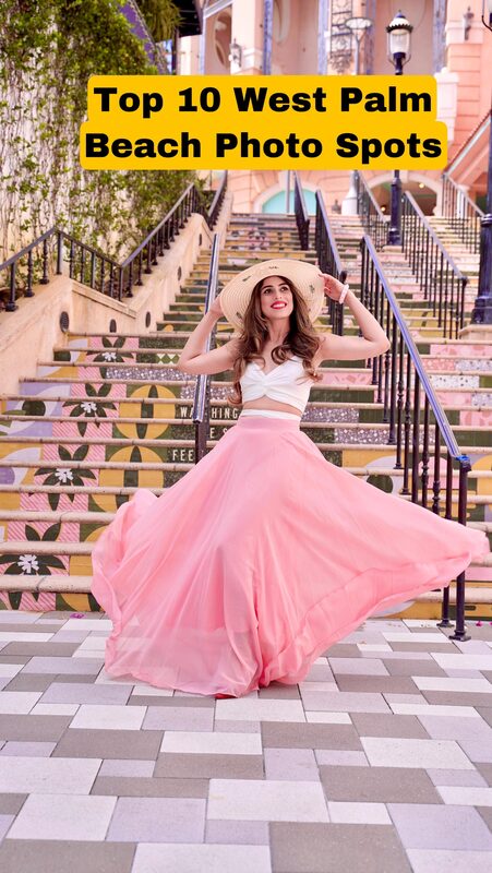 Roopsi Bansal in a yellow crochet halter-neck dress with a fringed hem, standing by an iron gate beside a bridge over the water in West Palm Beach at sunset