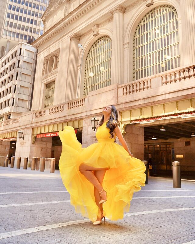 Roopsi Bansal in a yellow Essie One Shoulder Tulle Maxi Dress from Mew Mews outside Grand Central Terminal in New York City