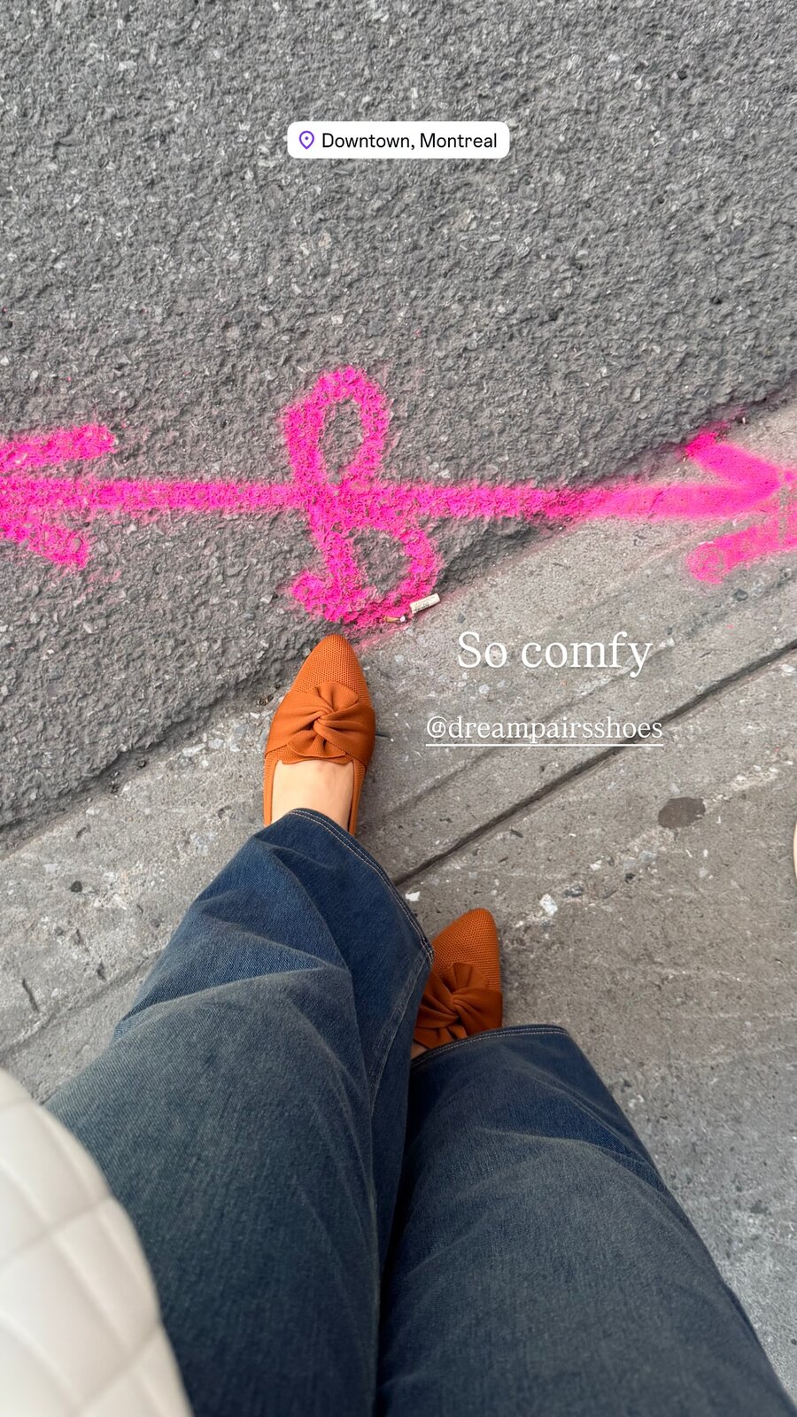 A downward view of rust-brown bow-front flats from Dream Pairs on a sidewalk marked with pink chalk, captioned So comfy