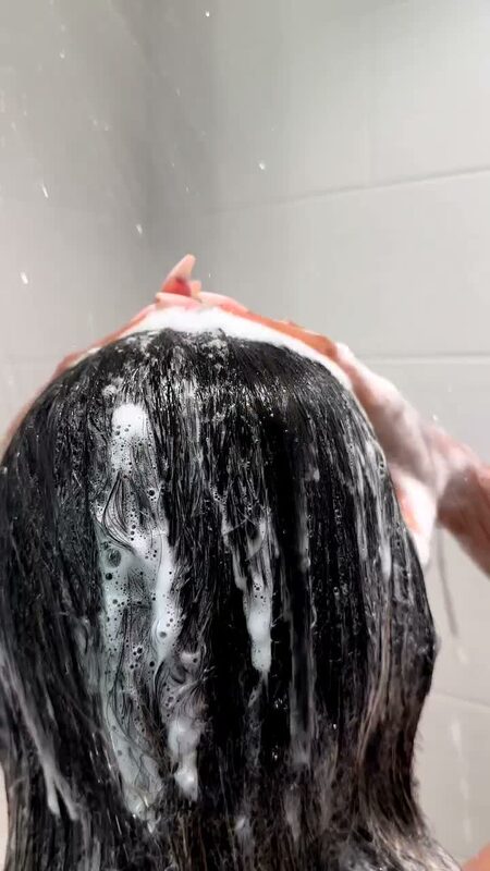 Roopsi Bansal washing her hair in the shower with Vatika Tropical Coconut shampoo, lather running through dark hair