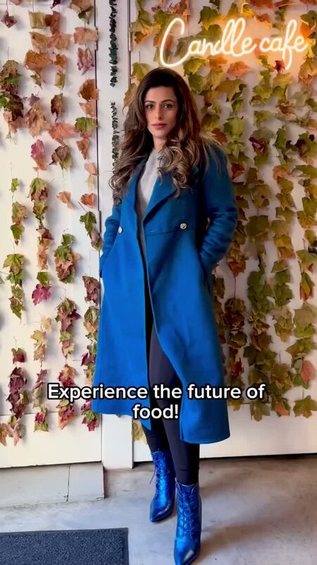 Roopsi Bansal trying a plant-based vegan salmon filet at Candle Cafe in NYC