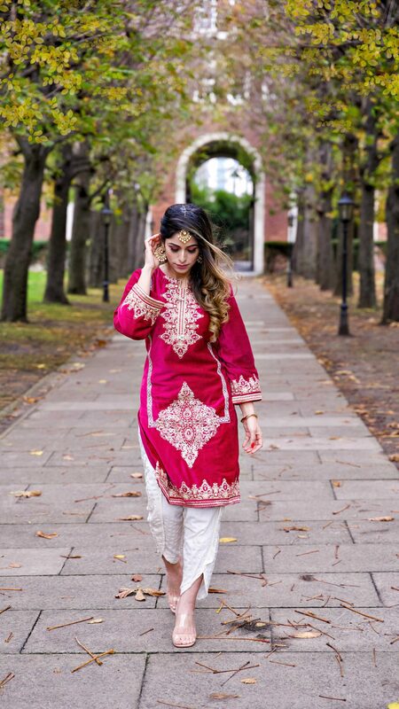 Roopsi Bansal in a magenta embroidered kurta, recording a reel indoors